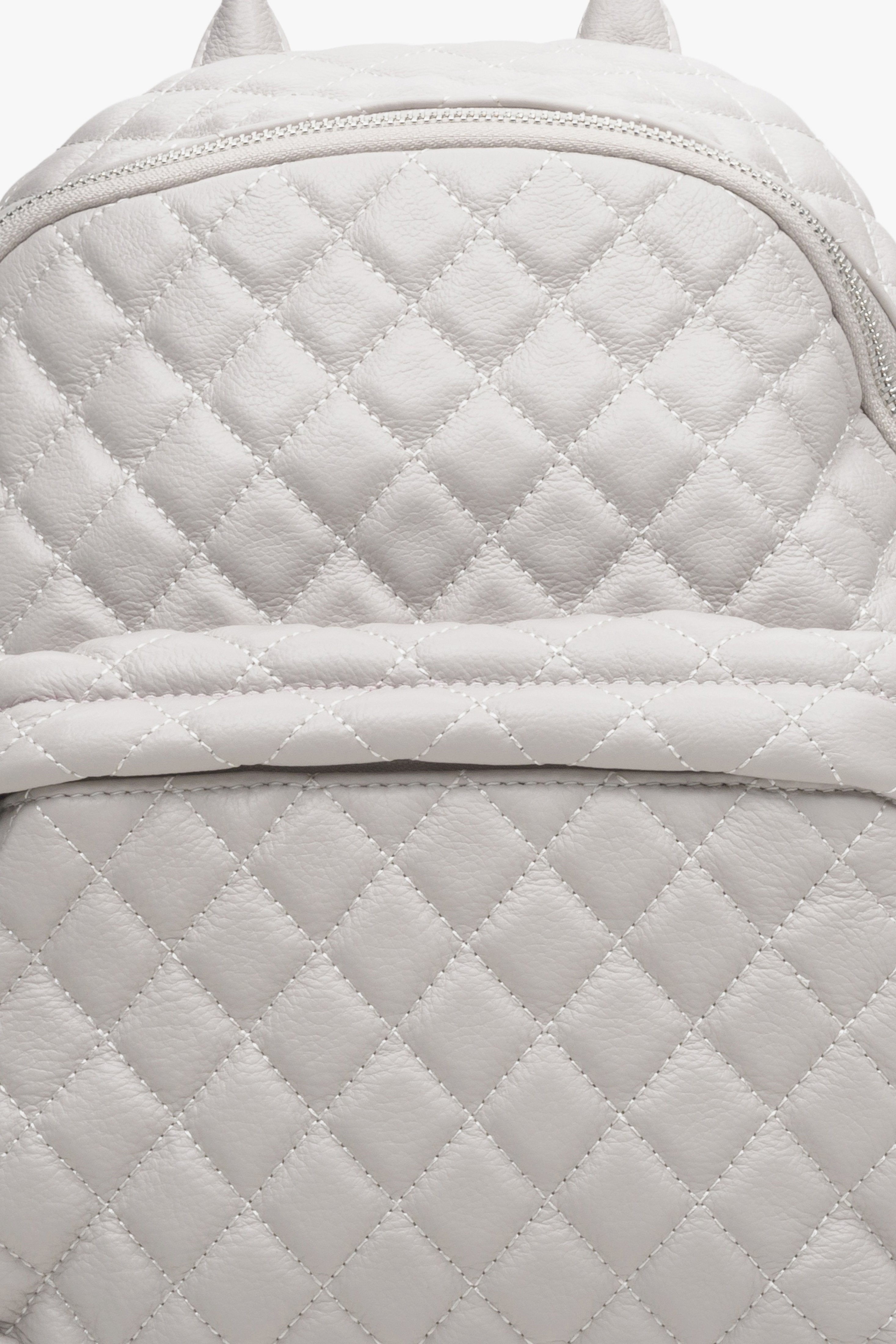 Women's light beige leather backpack by Estro - close-up of the stitching detail.