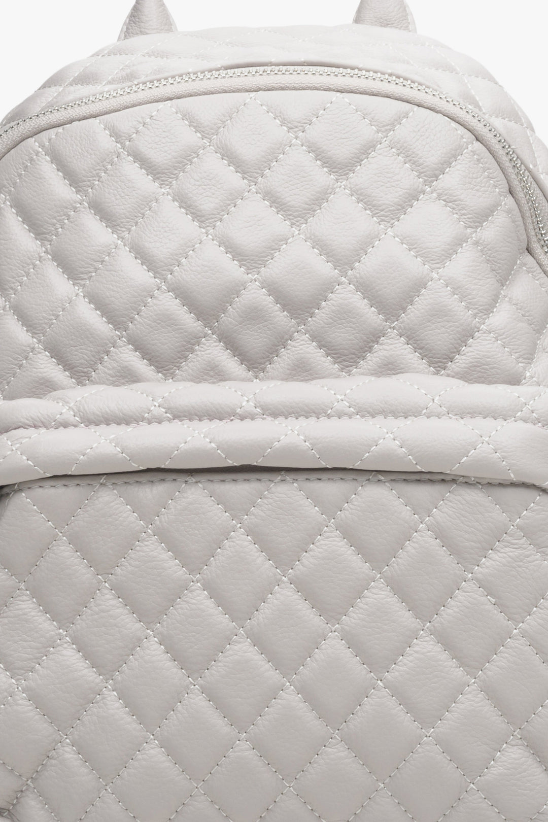 Women's light beige leather backpack by Estro - close-up of the stitching detail.