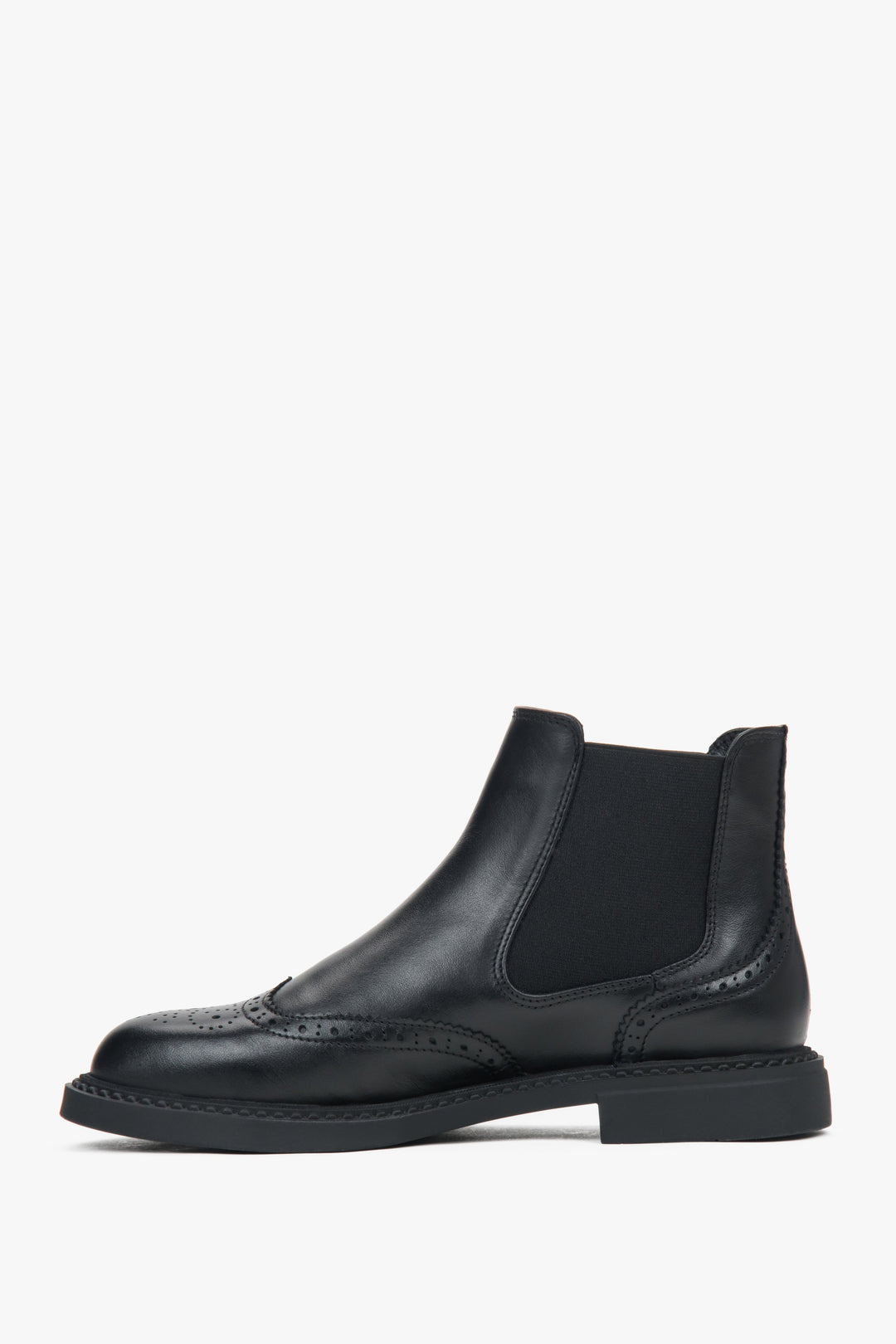 Side profile of a women's low-cut black Chelsea boot, showing the perforation detail on the premium leather.