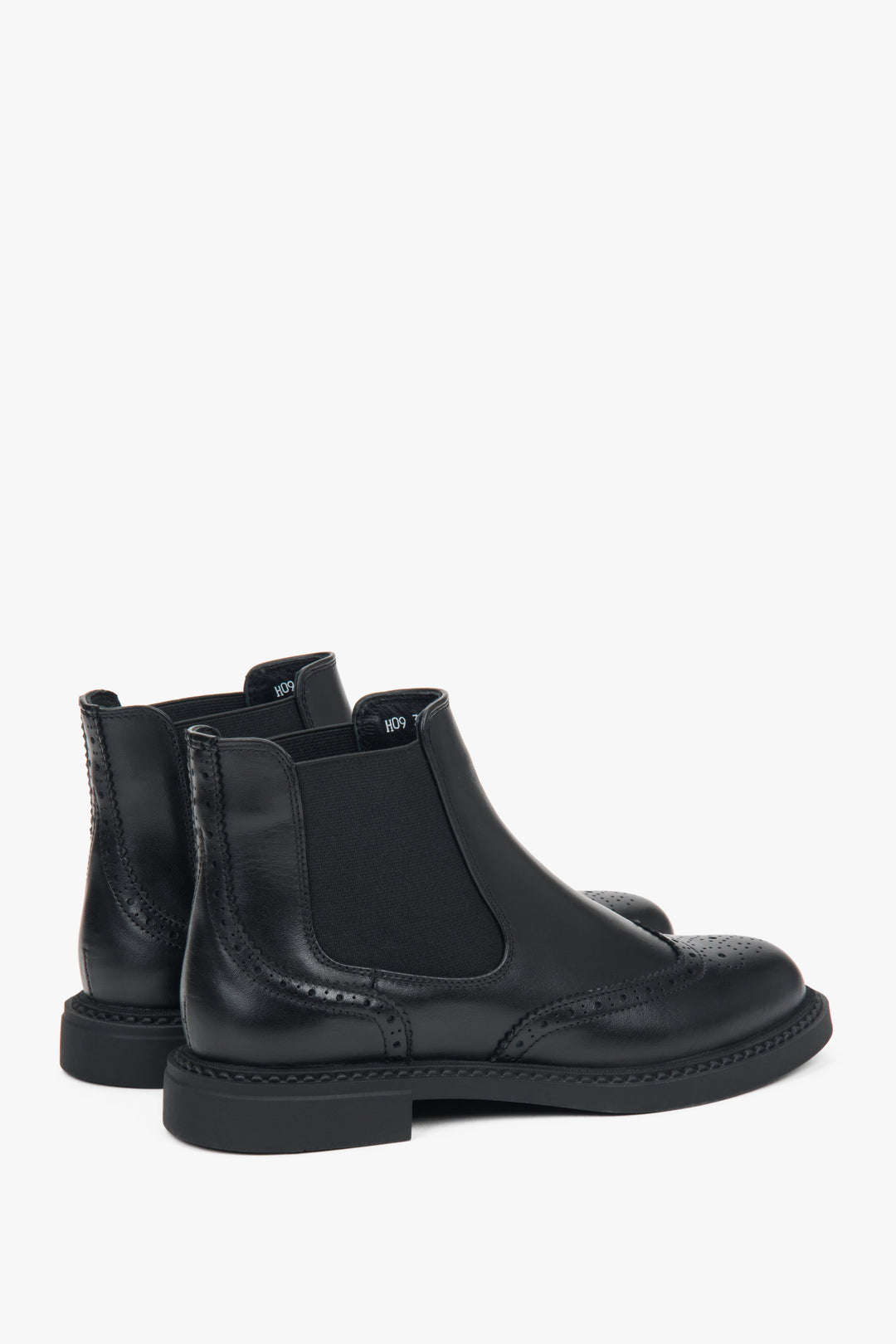 Premium Italian genuine leather crafted into low-cut women's black Chelsea boots with perforated accents.