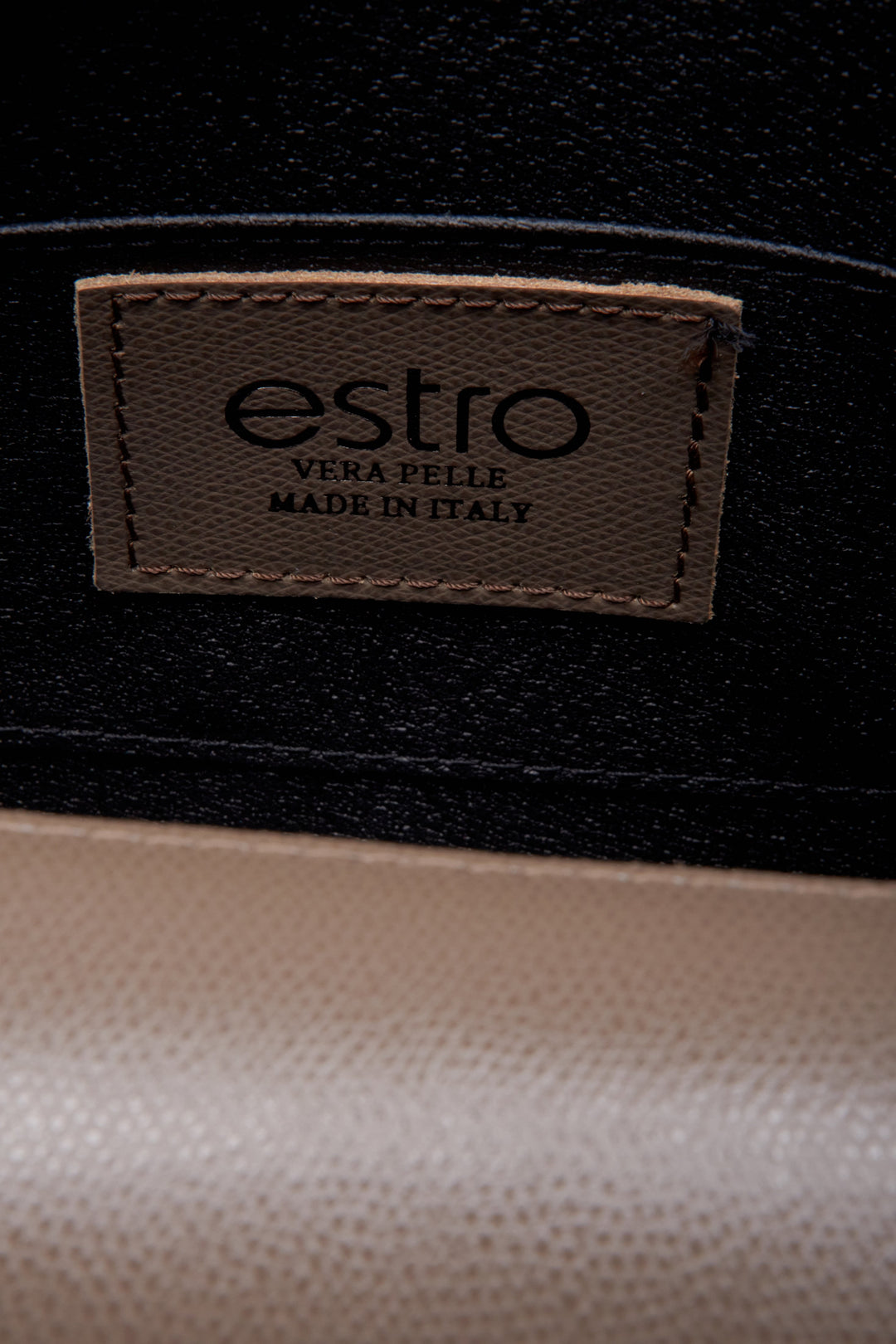 Women's brown leather handbag by Estro - close-up on details.