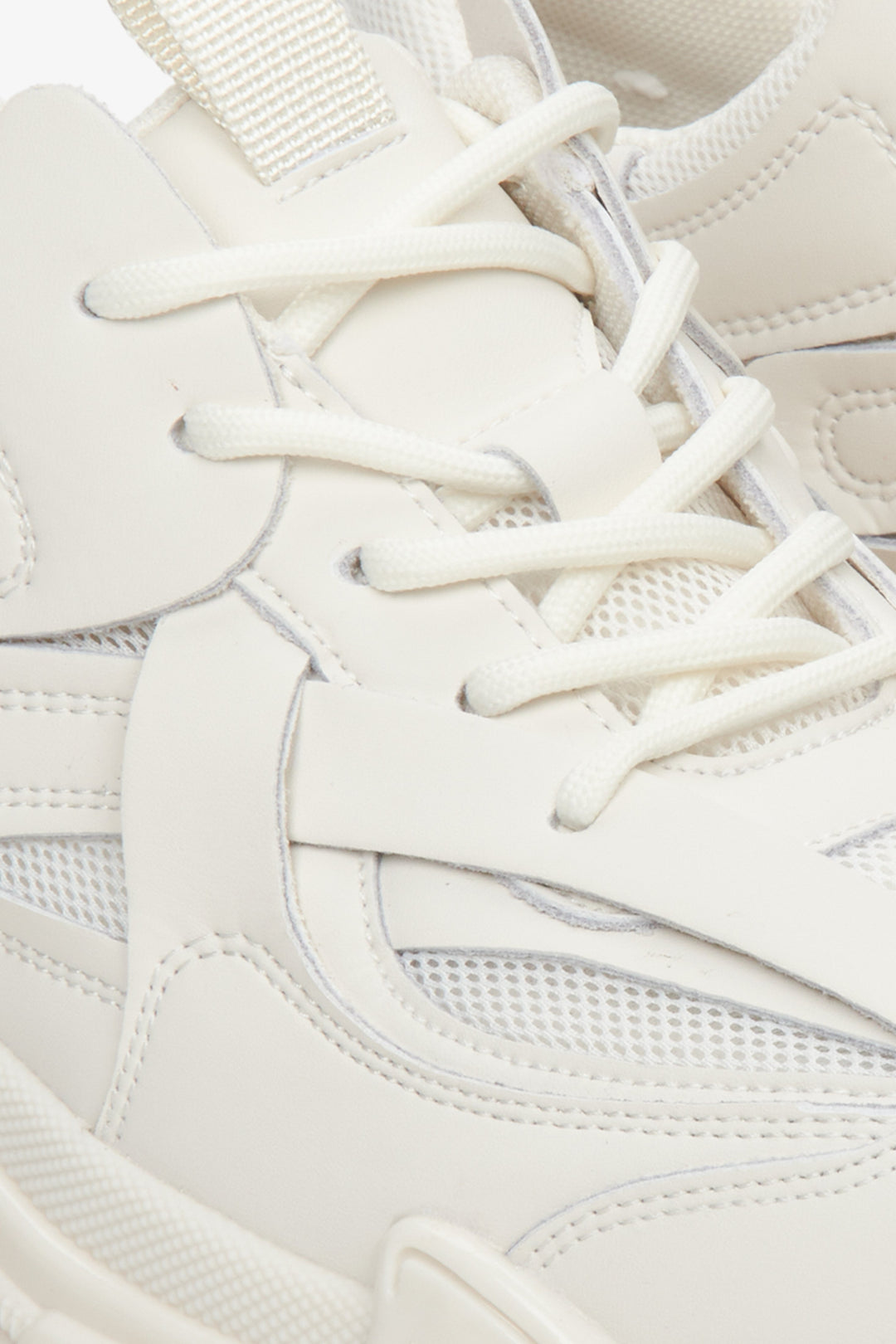 Women's white sneakers made of genuine leather and textile material for spring and autumn - close-up of the lacing system.