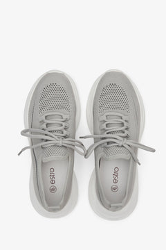 Women's grey low top sneakers made of mesh and textile - presentation of the footwear from above.