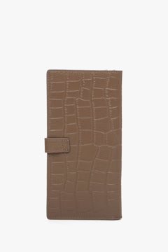 The back of a large brown women's wallet made of embossed genuine leather with gold details by Estro.