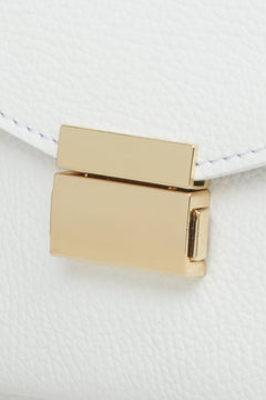 Women's small white handbag made of premium Italian genuine leather - close-up on details.