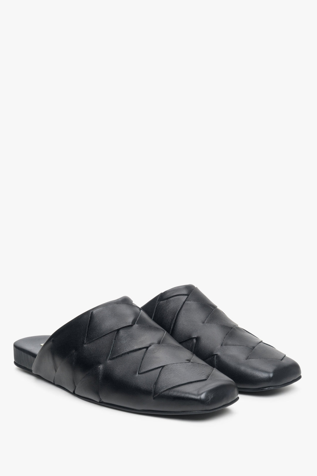 Women's black leather slides with a covered toe line.