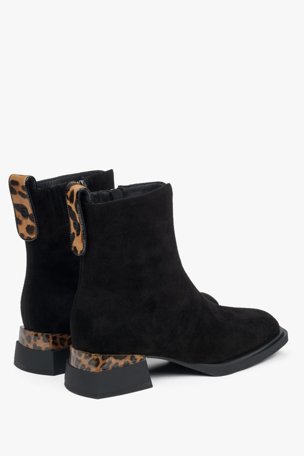 Black velour ankle boots for women with low heels and animal print inserts – close-up of the heel and side line of the shoes.