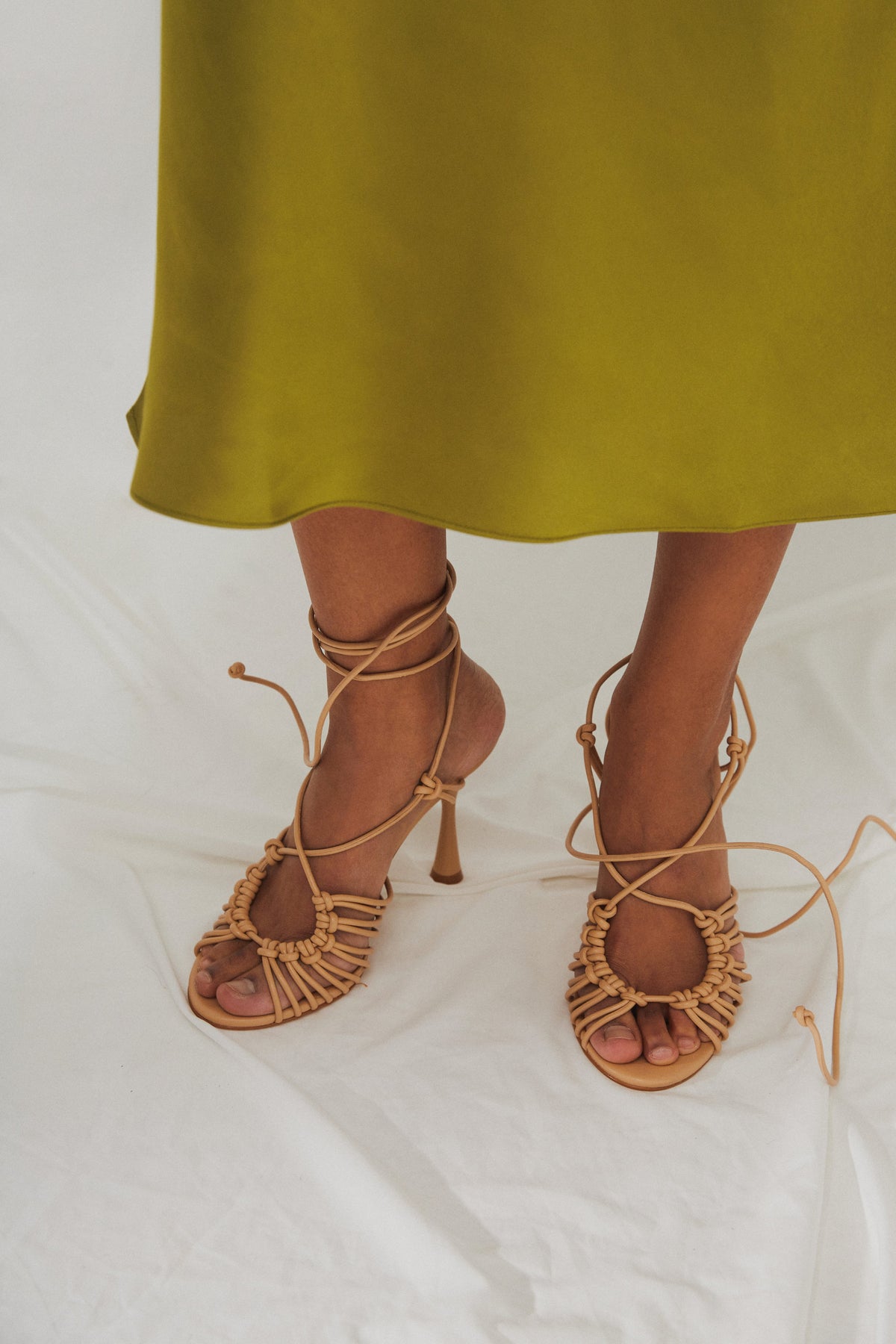 Women's beige leather lace-up sandals by Estro - presentation on a model.