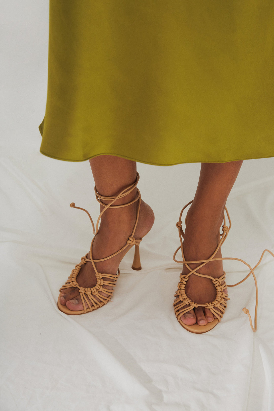 Women's beige leather lace-up sandals by Estro - presentation on a model.
