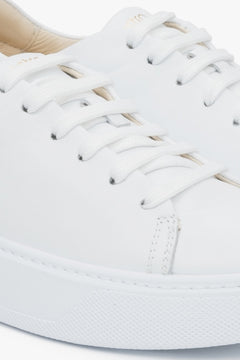 Close-up on details of white women's sneakers made of genuine leather Estro.