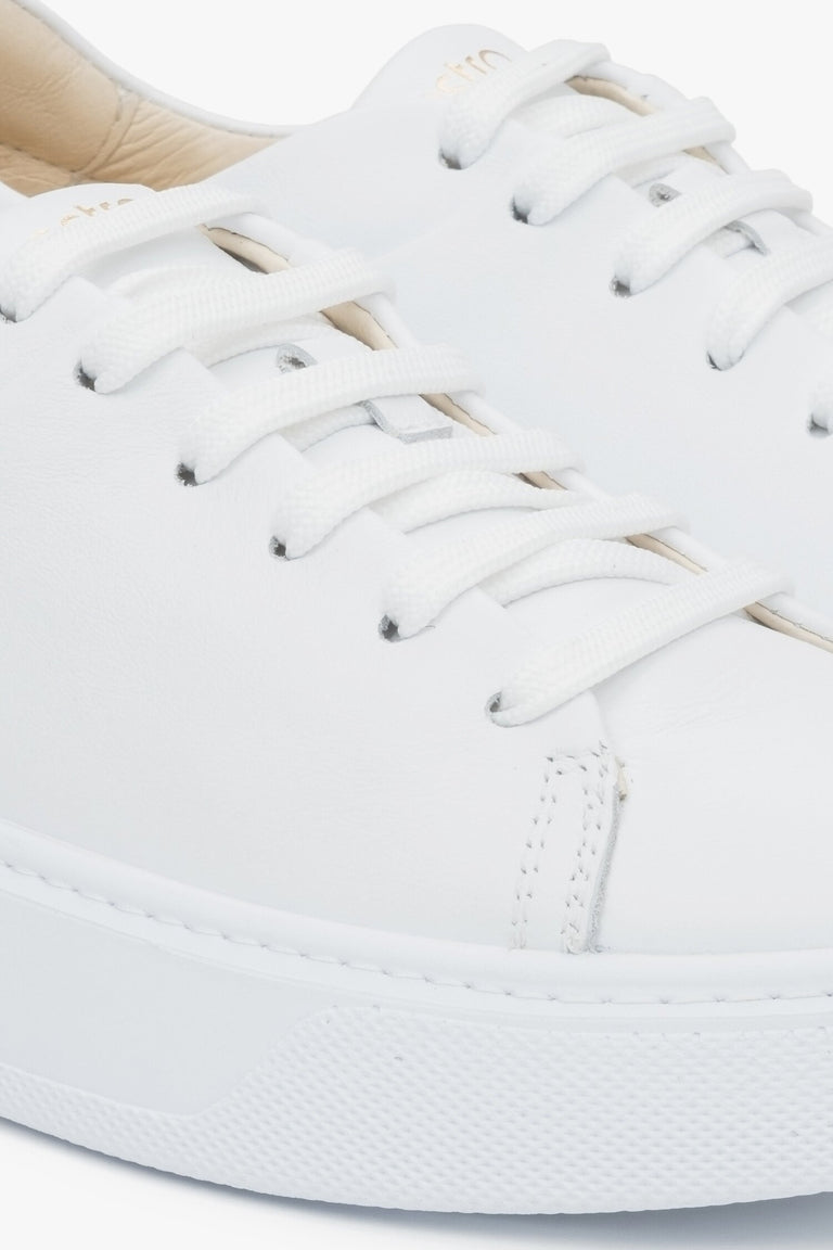 Close-up on details of white women's sneakers made of genuine leather Estro.