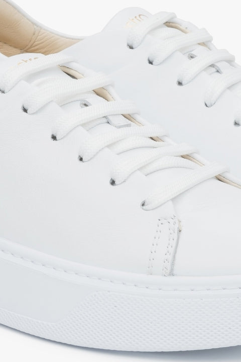 Close-up on details of white women's sneakers made of genuine leather Estro.