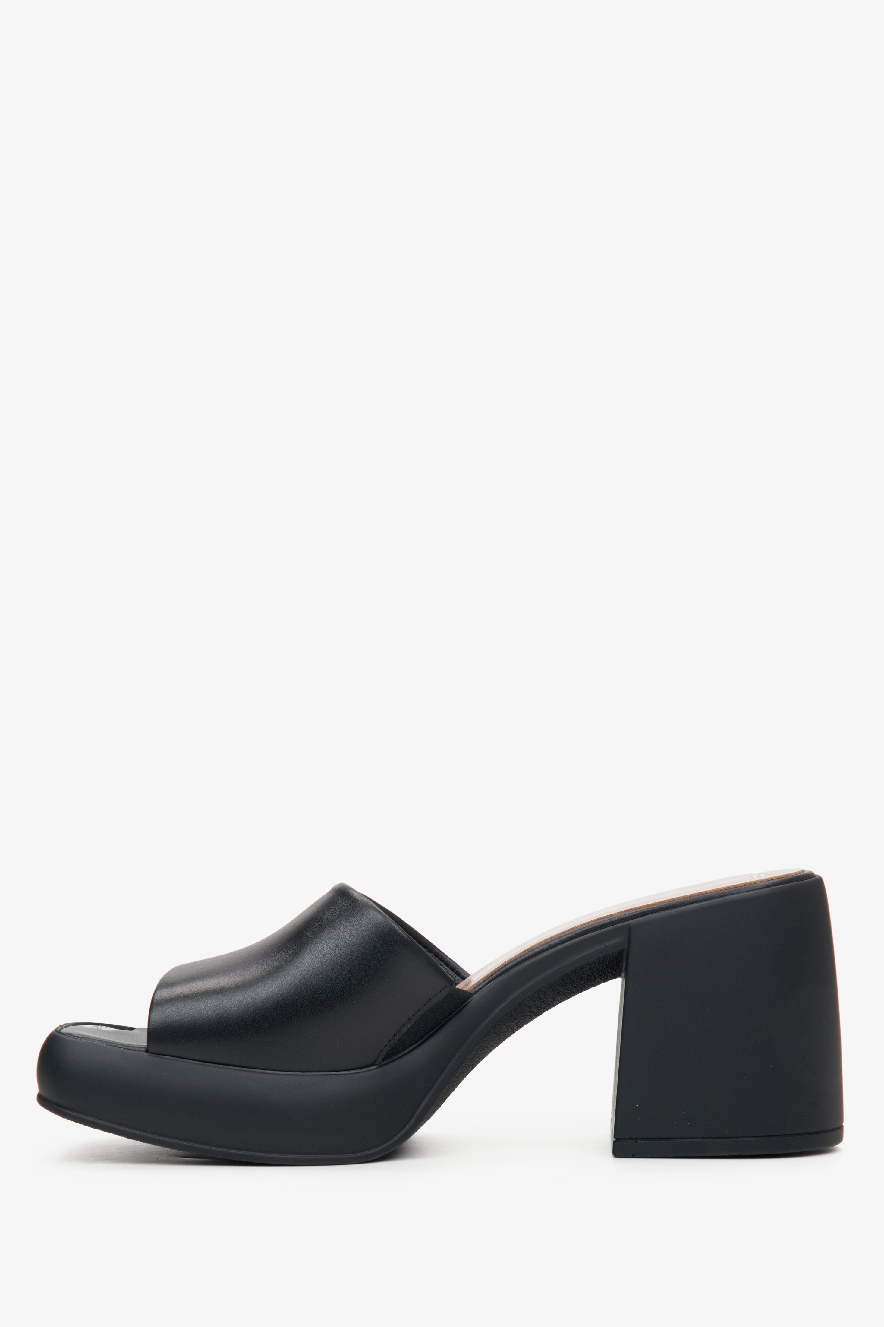 Stylish black mules for women made of natural leather on a square heel - the profile of the shoes.