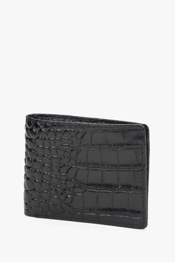 Close-up of black leather with crocodile-skin texture.
