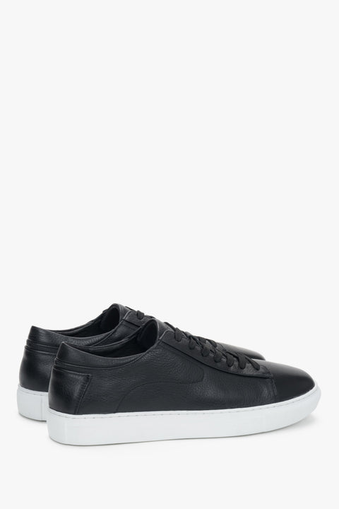 Stylish black leather sneakers with a modern contrasting outsole.