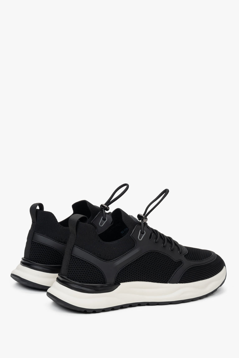 Black and white sneakers with a flexible sole in a contrasting color.