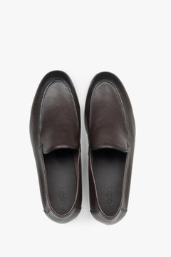 Polished dark brown leather men's loafers with a flat rubber sole and slip-on fit.