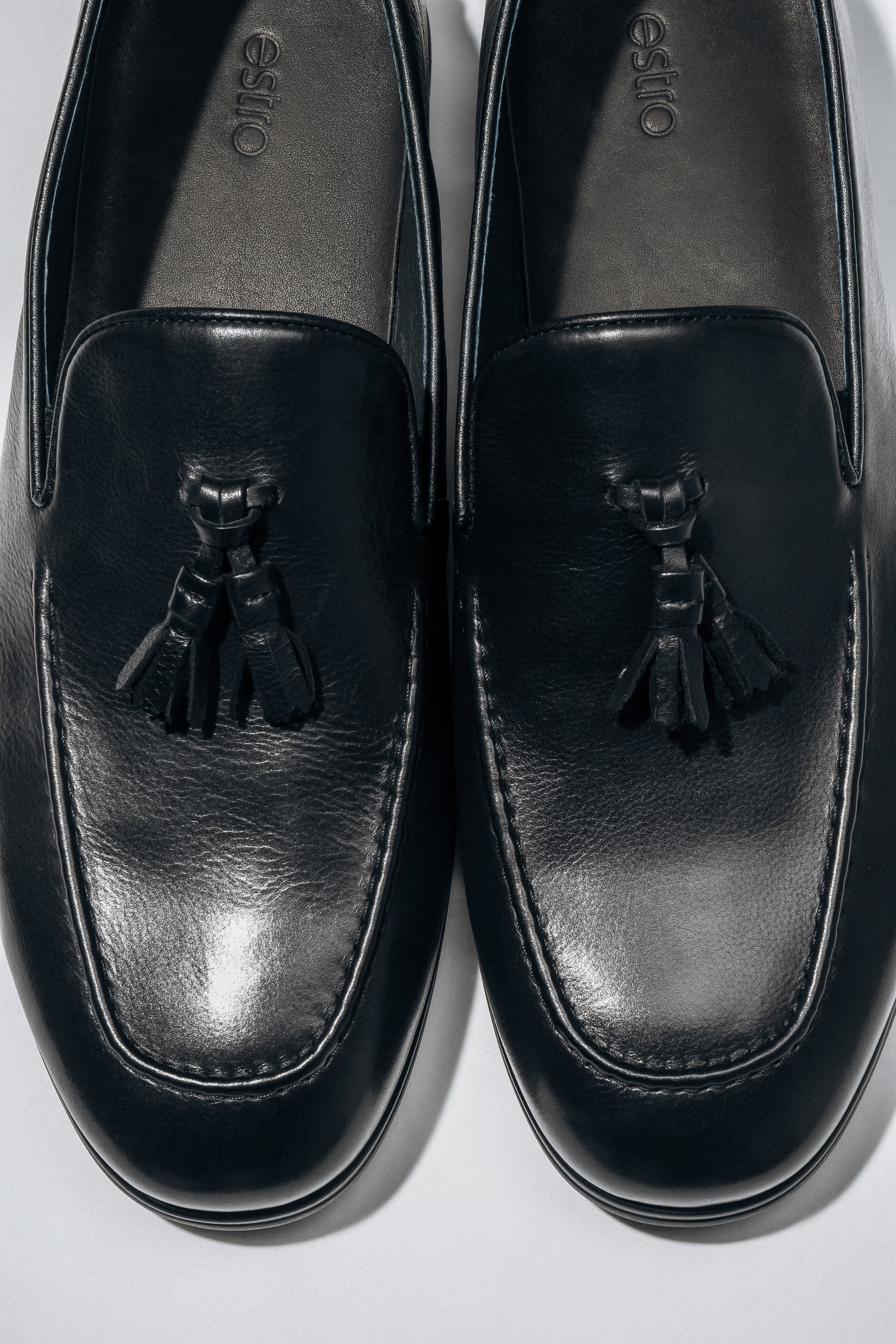 Classic black men’s loafers with a flat rubber sole.