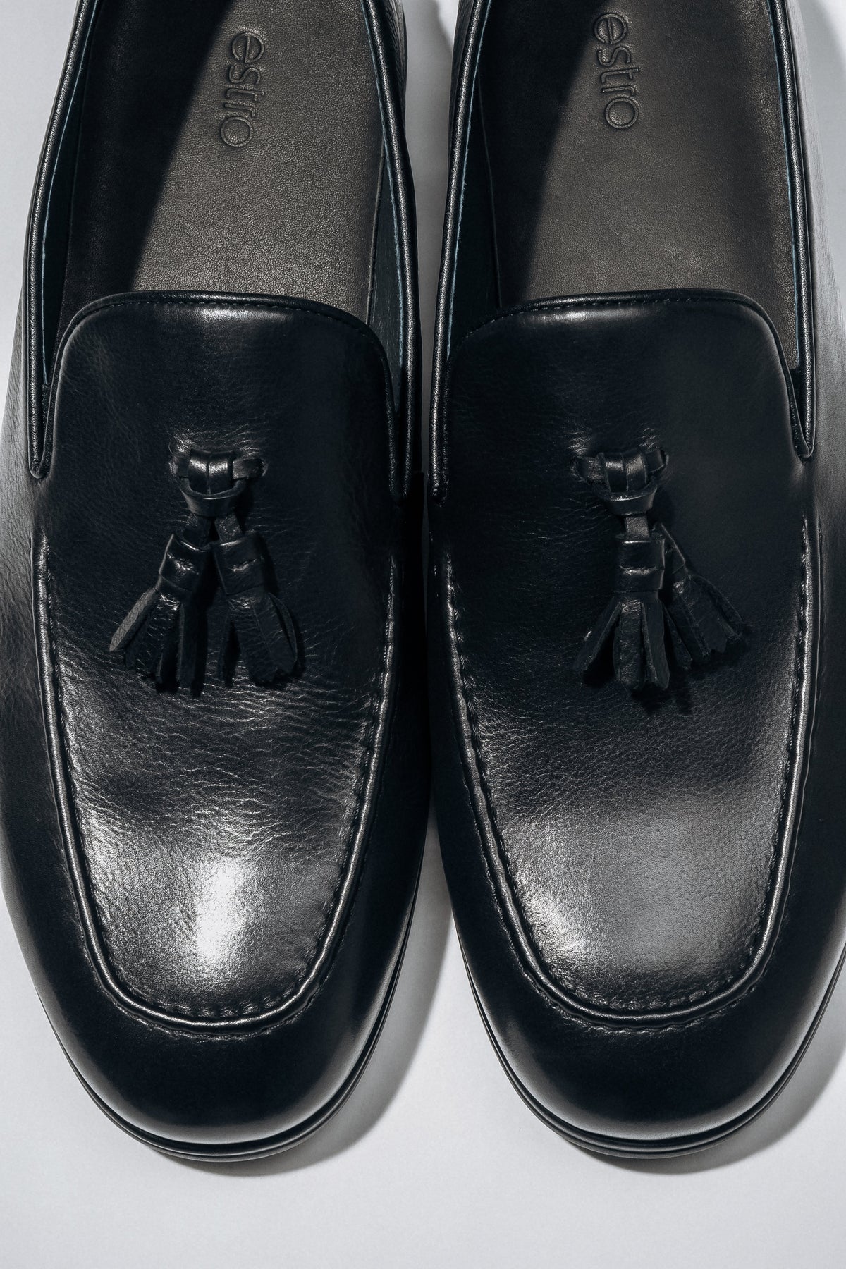 Classic black men’s loafers with a flat rubber sole.