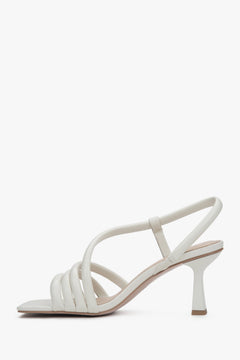 Women's milky white leather sandals Estro, showcasing the stable 7 cm block heel and elegantly tailored, smooth upper straps.