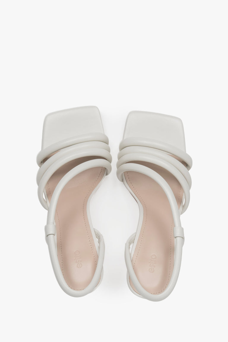 A top view of the pair of slip-on sandals, highlighting the luxury genuine chevro leather insole with a subtly embossed Estro logo.