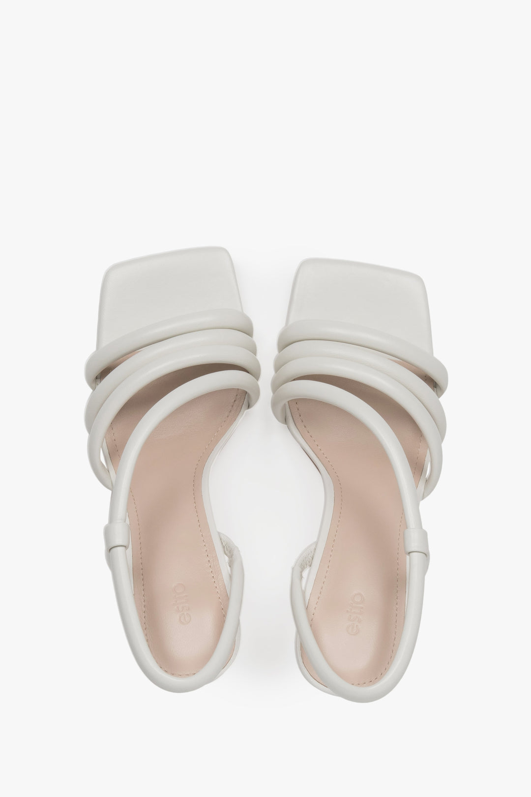 A top view of the pair of slip-on sandals, highlighting the luxury genuine chevro leather insole with a subtly embossed Estro logo.