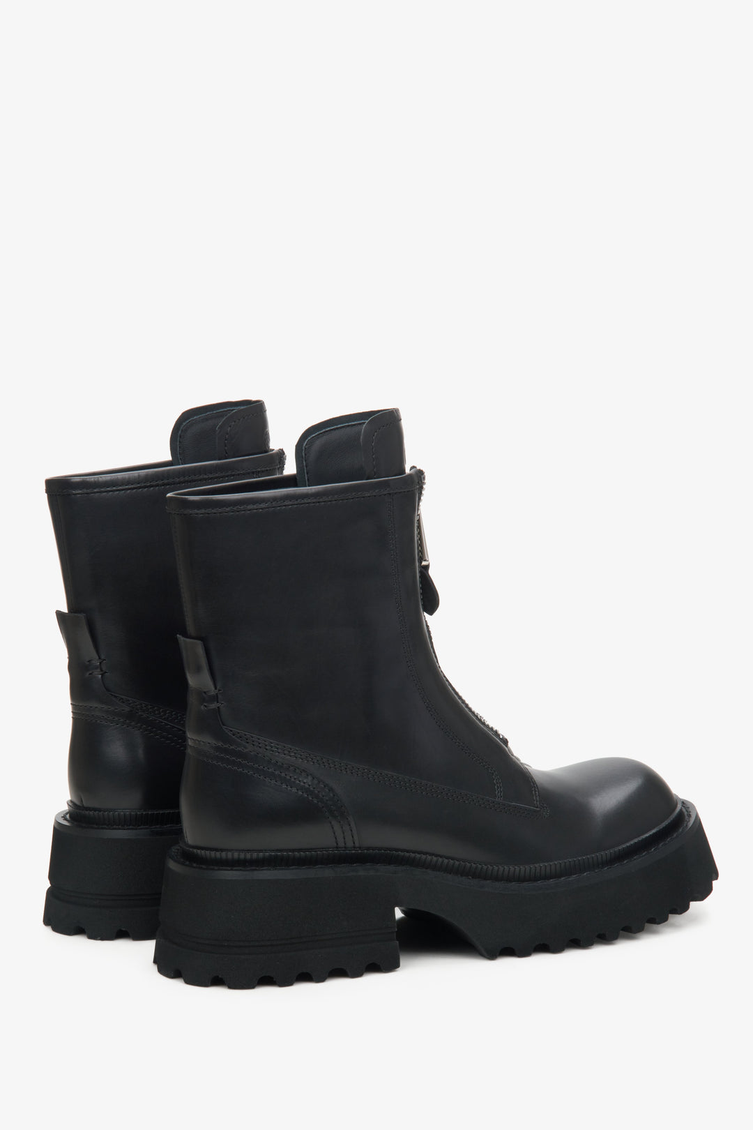 Women's black boots made of genuine leather with a decorative zipper - close-up on the side line and heel counters.