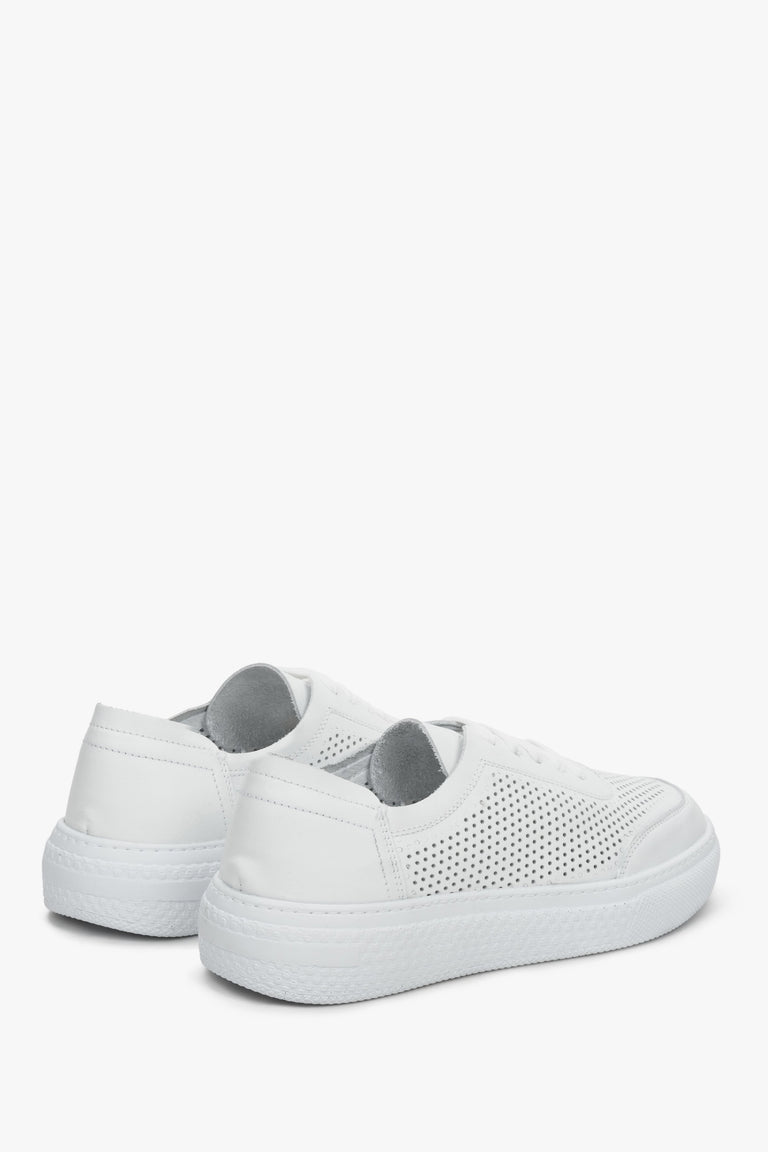 Women's white leather sneakers with perforation from Estro brand - close-up of the heel counter and the side of the shoe.