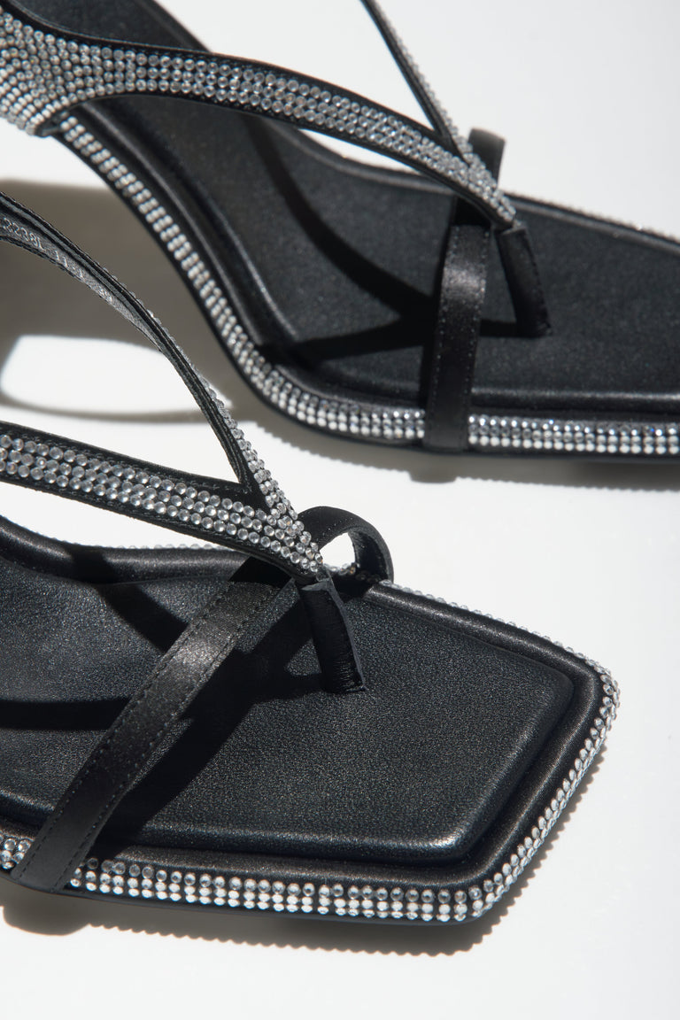 Women's black heeled sandals with diamonds - a close-up on details.