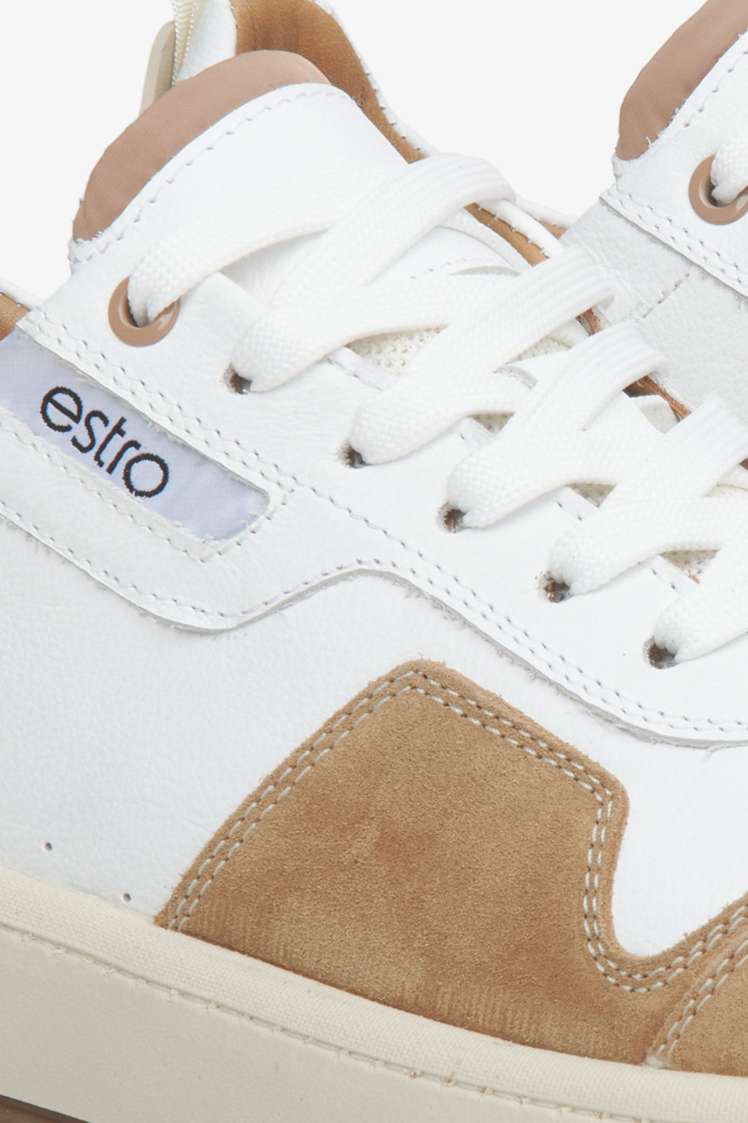 Men's leather-velour sneakers in white-brown color - close-up on details.