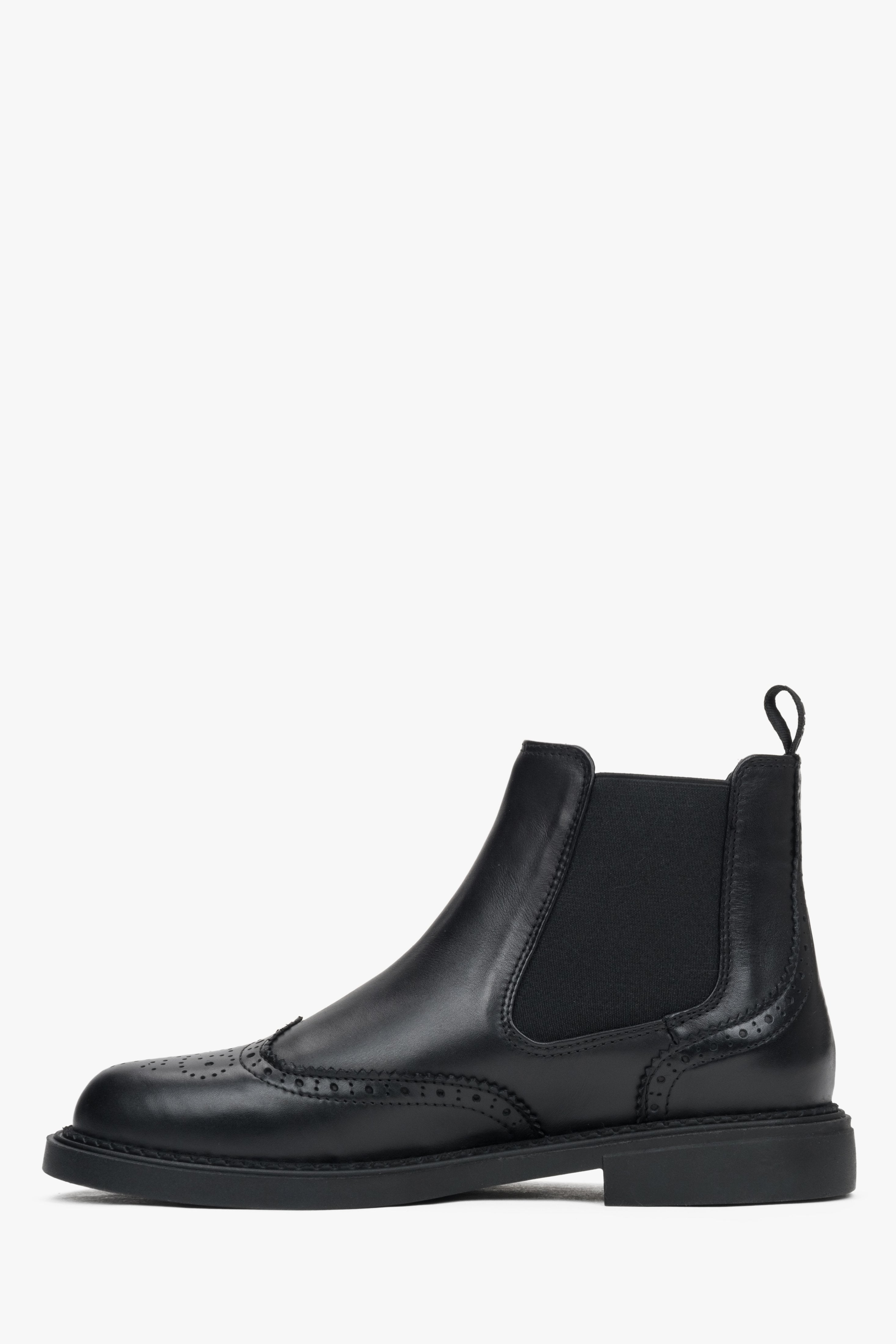 Black low-top Chelsea boots made of genuine leather with folk perforations by Estro - side profile of the shoe.