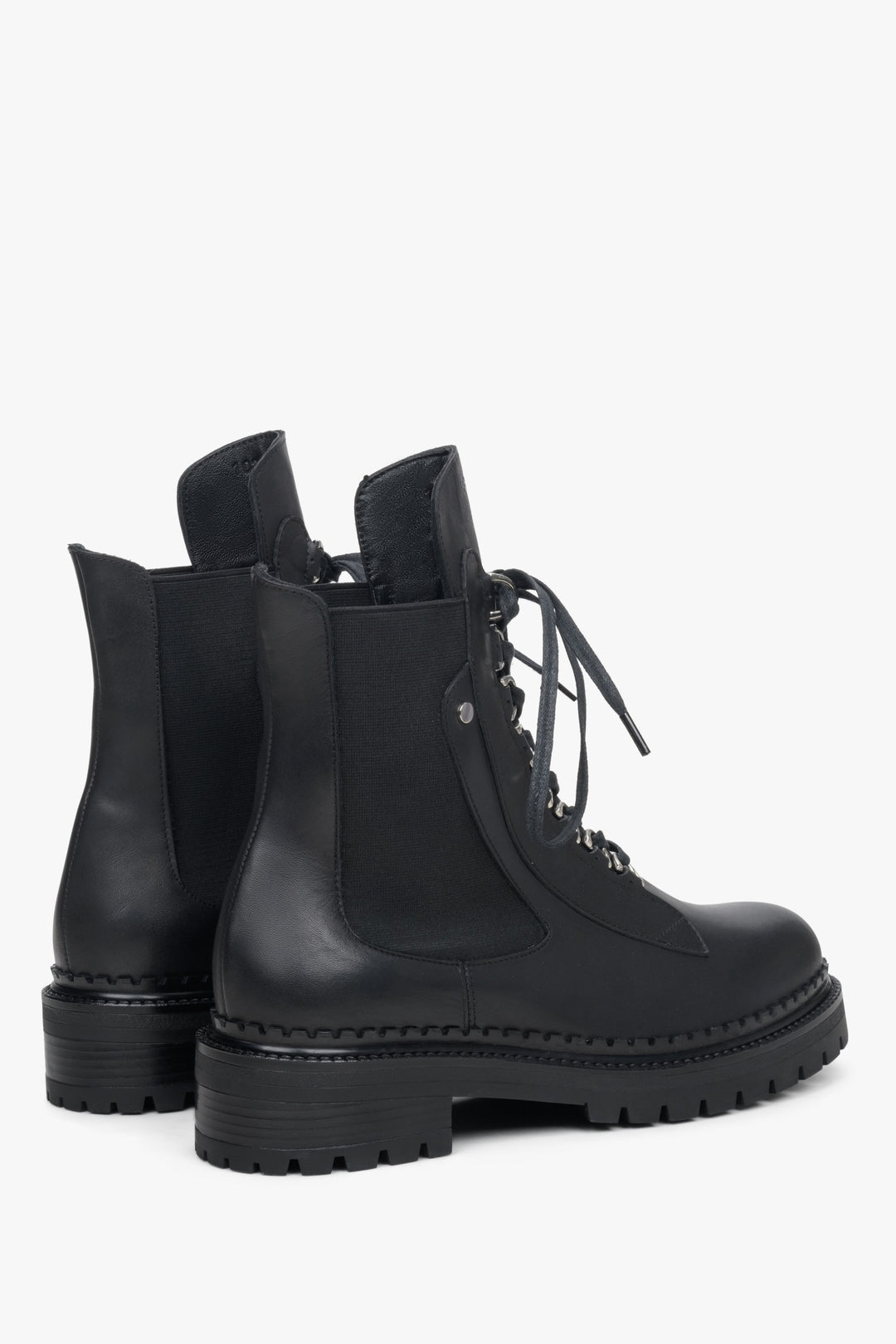 Women's black leather ankle boots in black - close-up on shoeline.