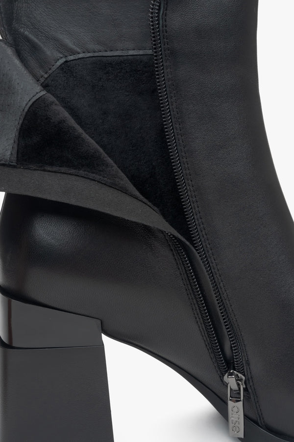 Black leather women's ankle boots with a block heel and light insulation - interior view of the model.