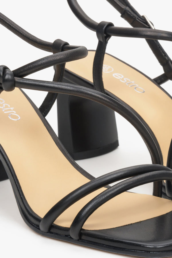Leather strappy black sandals of Estro brand - a close-up on details.