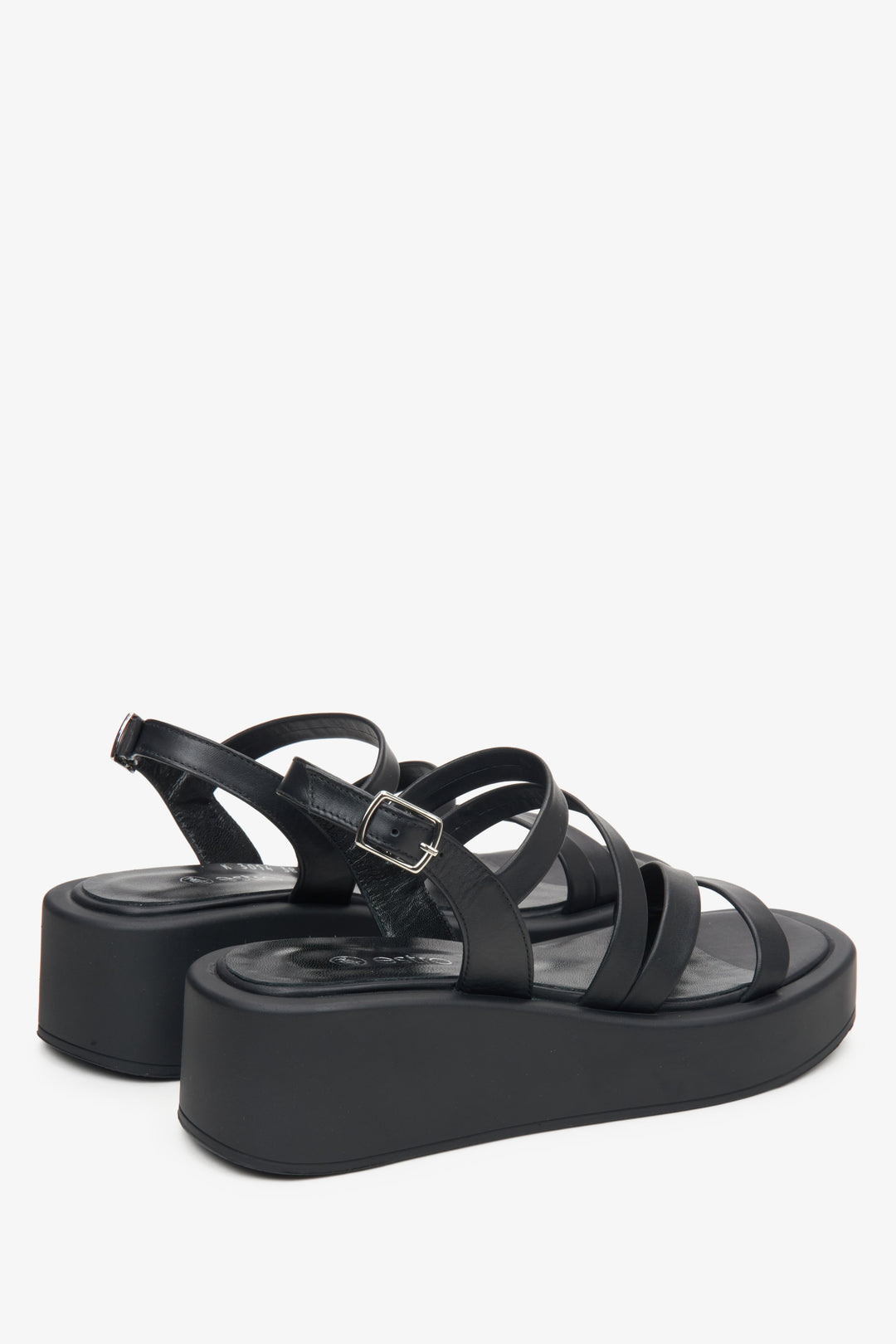 Women's leather black wedge sandals by Estro - close-up on the side line and heel of the shoe.
