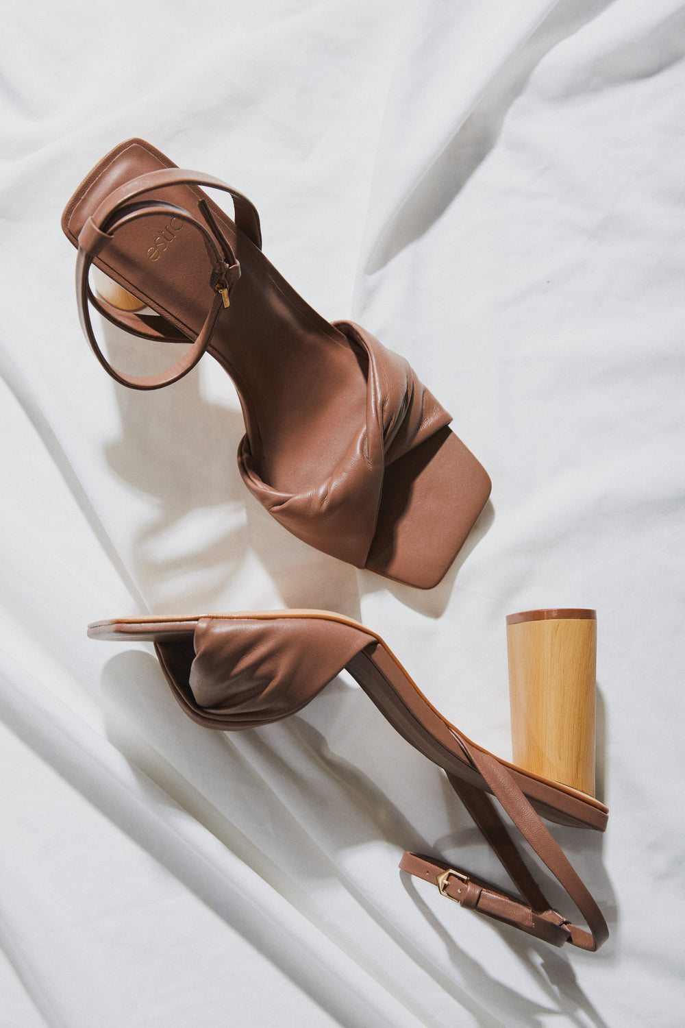 Estro brown leather ankle strap sandals with a block heel.