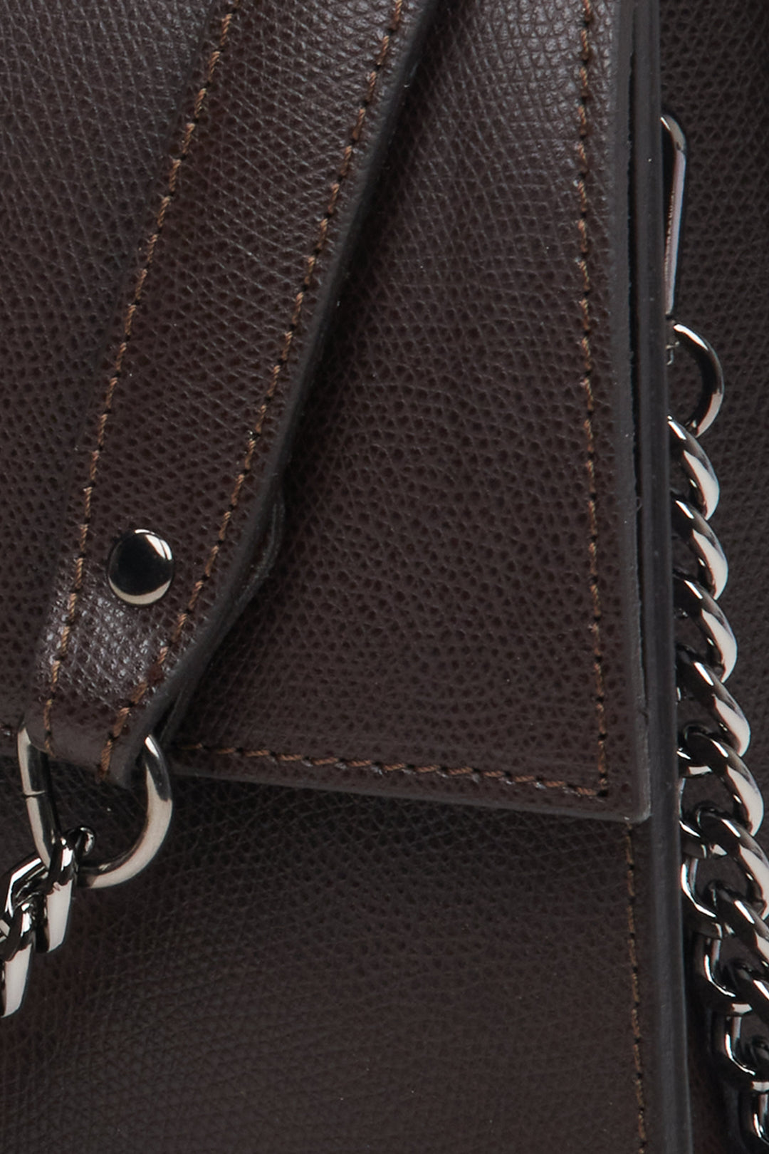 Women's dark brown leather handbag with a flap by Estro - close-up on the details.