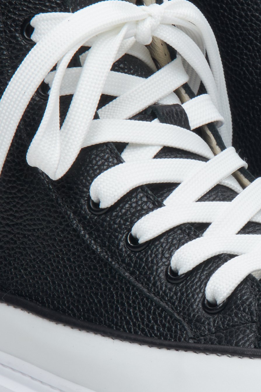 High-top leather women's sneakers in black and white by Estro - close-up of the lacing system.