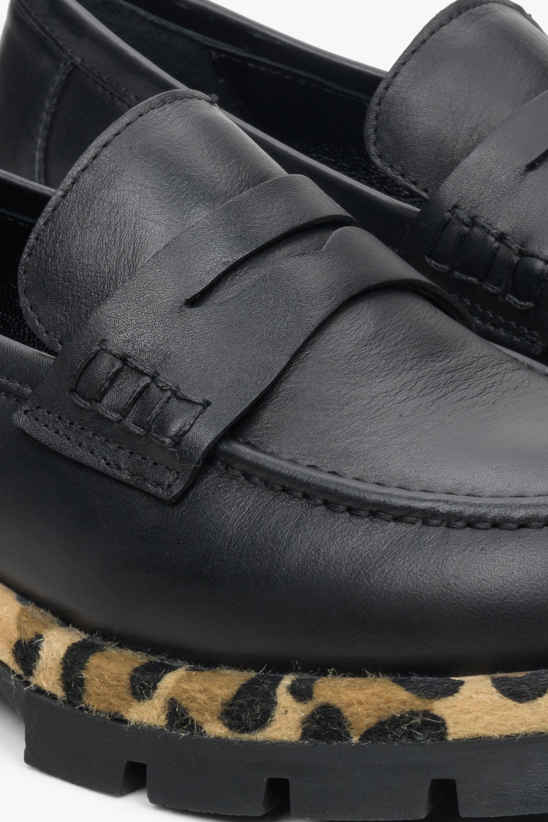 Women's black leather moccasins by Estro - close-up on details.