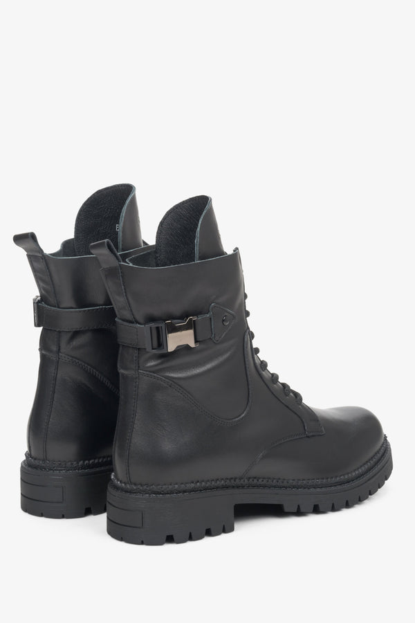 Estro black leather women's boots with a decorative buckle - close-up on the back and side seam of the shoe.