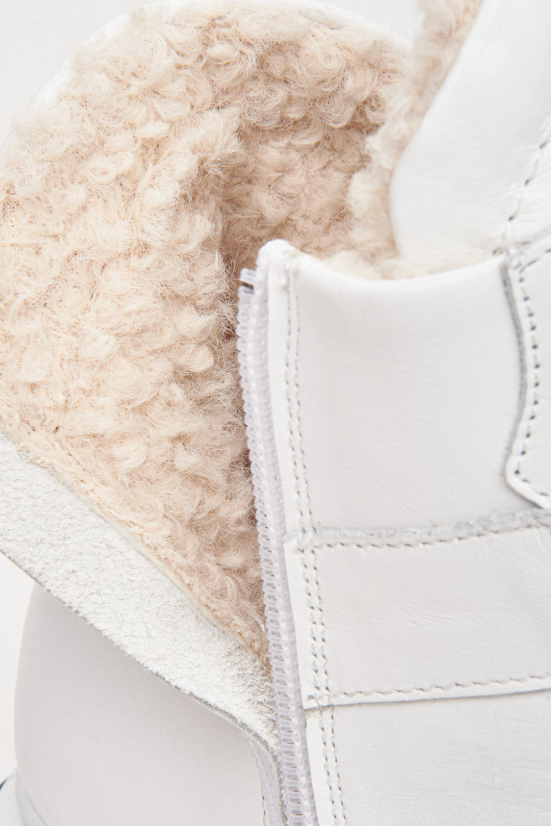 White, leather and suede high-top women's winter sneakers by Estro - close-up on the lacing system.