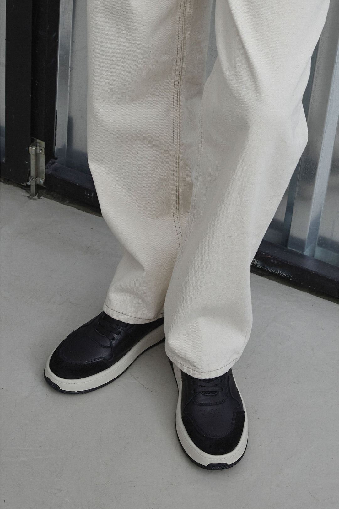 Men's low-top black sneakers - fully-stylized model.