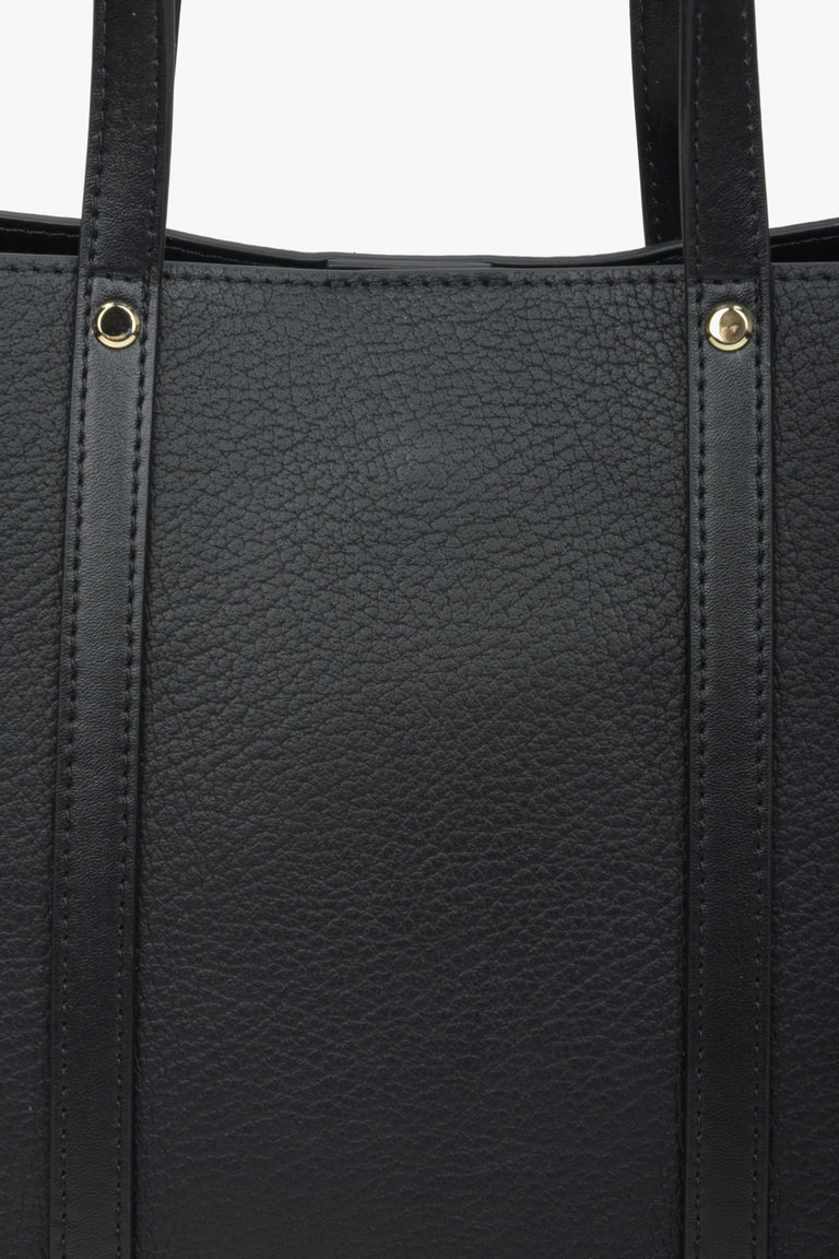 Women's black shopper bag made of genuine leather - close-up on details.