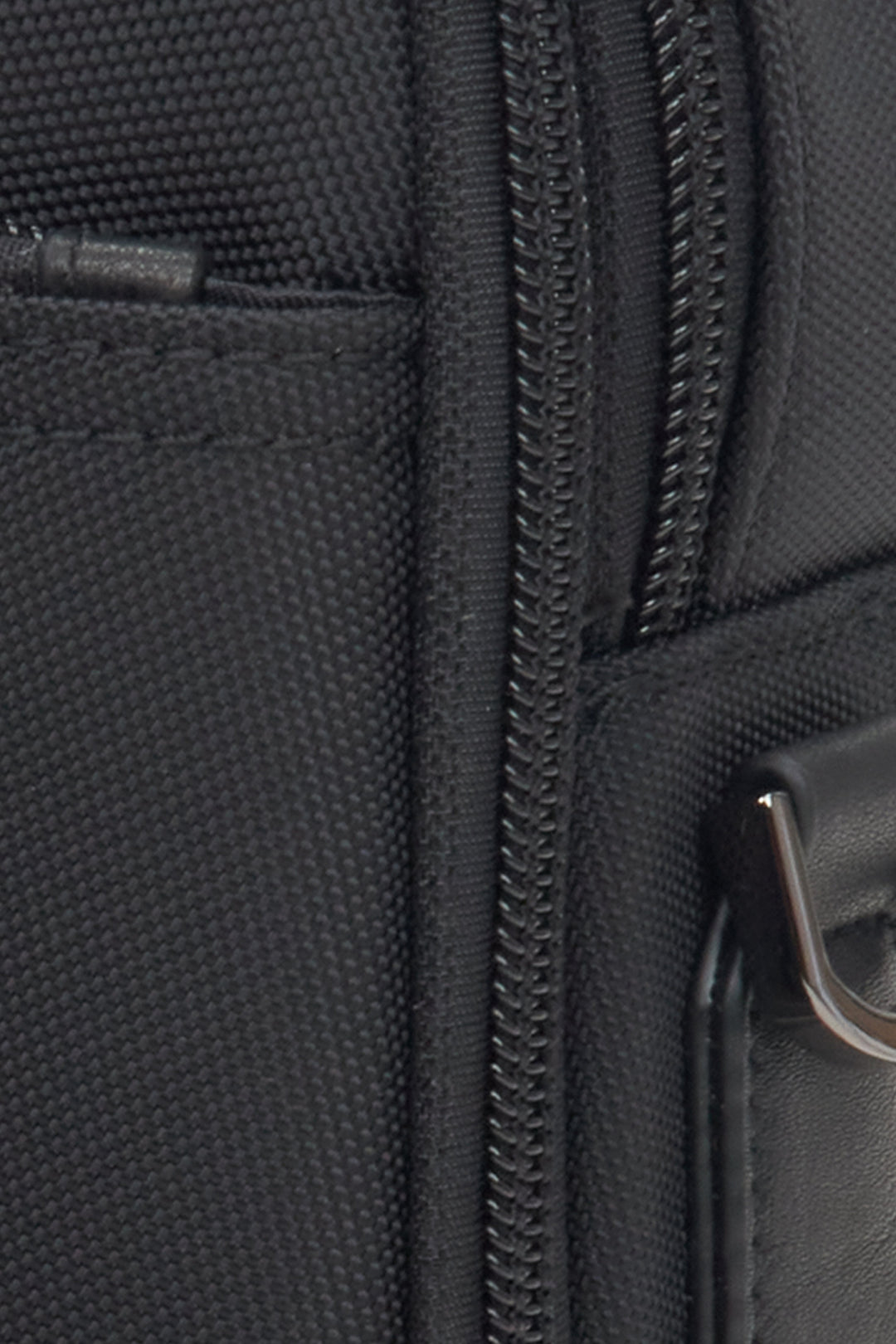 Close-up on the detail of the men's black bag by Estro.