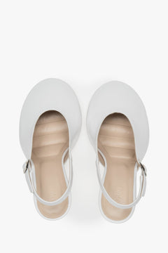 White slingback heels in Italian patent leather.