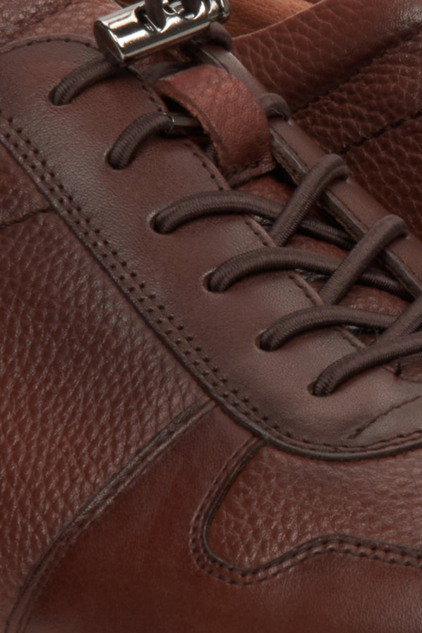 Men's brown leather sneakers with an elastic cuff - close-up on the details.