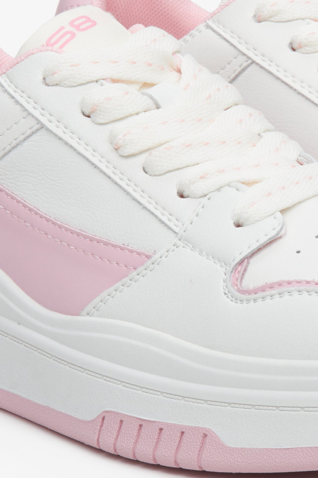 Sophisticated women's white and pink leather sneakers  - close-up on details.