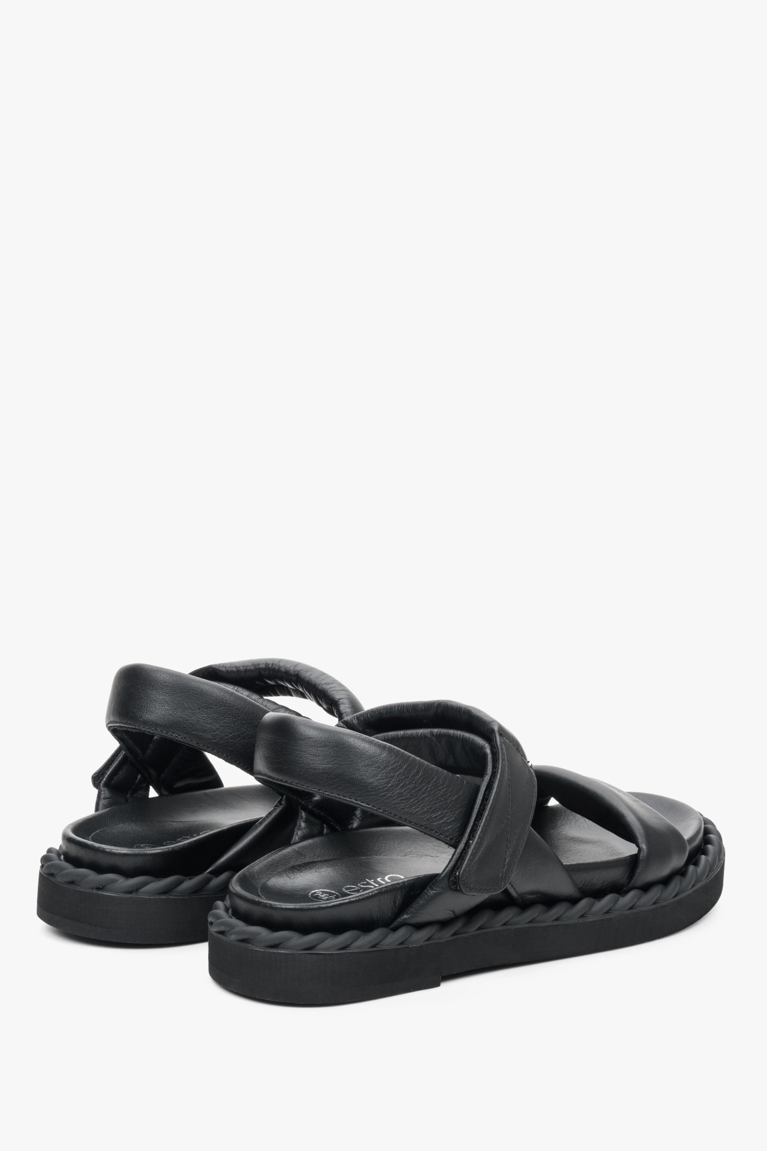 Women's black flat sandals for summer on a comfortable, flexible sole - the presentation of the back and side of the shoes.