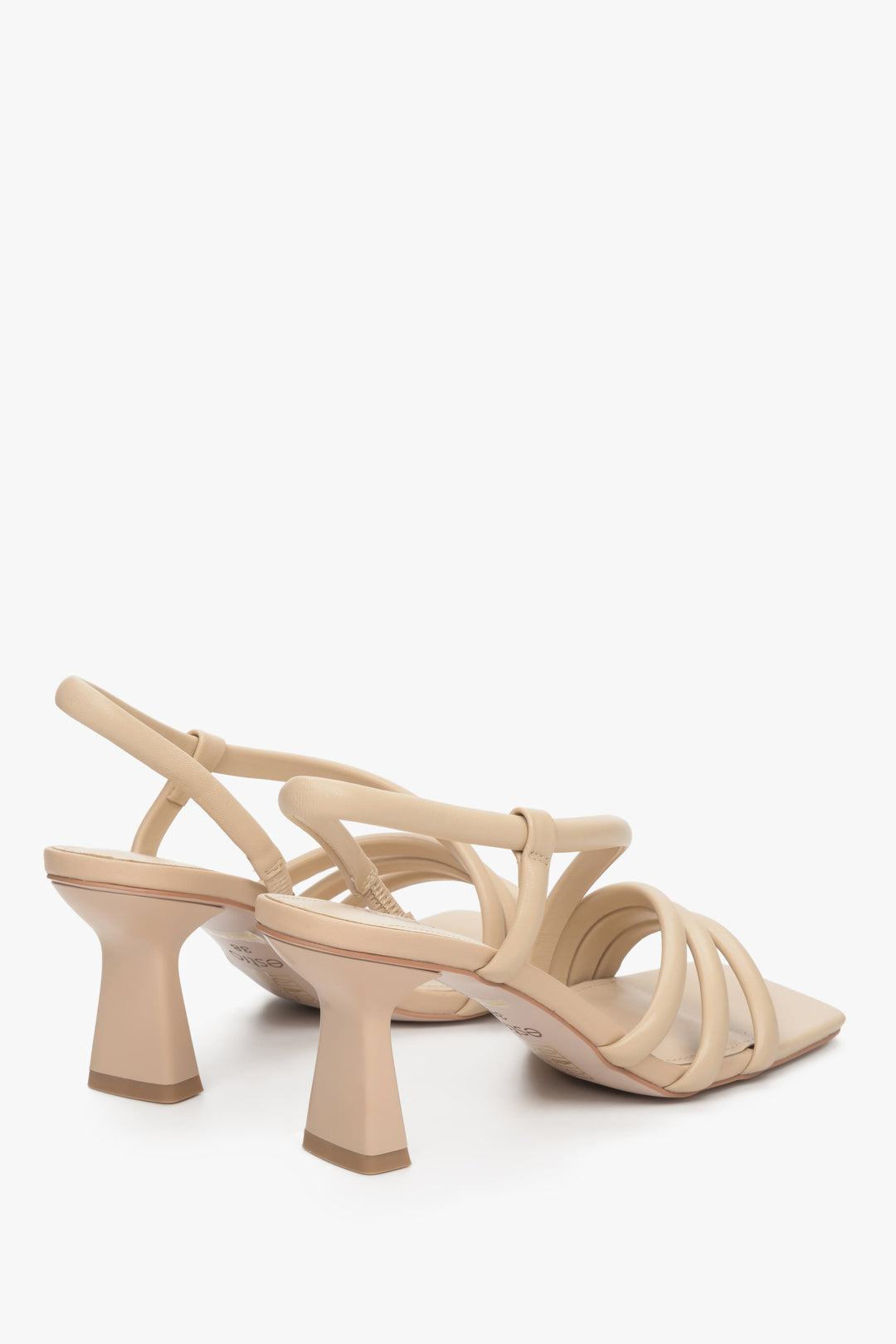 Women's beige strappy sandals made of natural leather - a close-up on heel and shoe sideline.