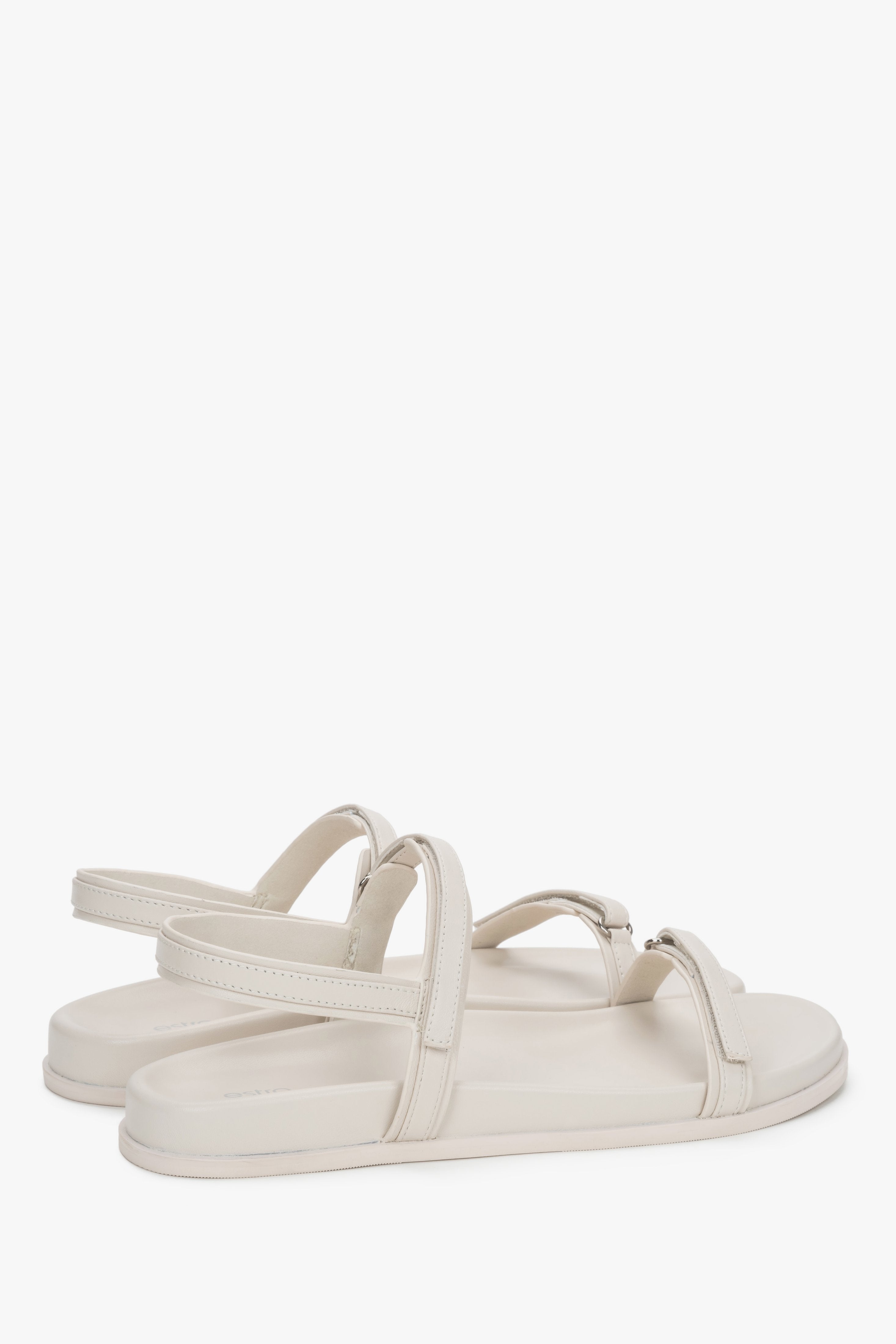 Side profile of women's off-white sandals, showing the flat sole and genuine leather straps.